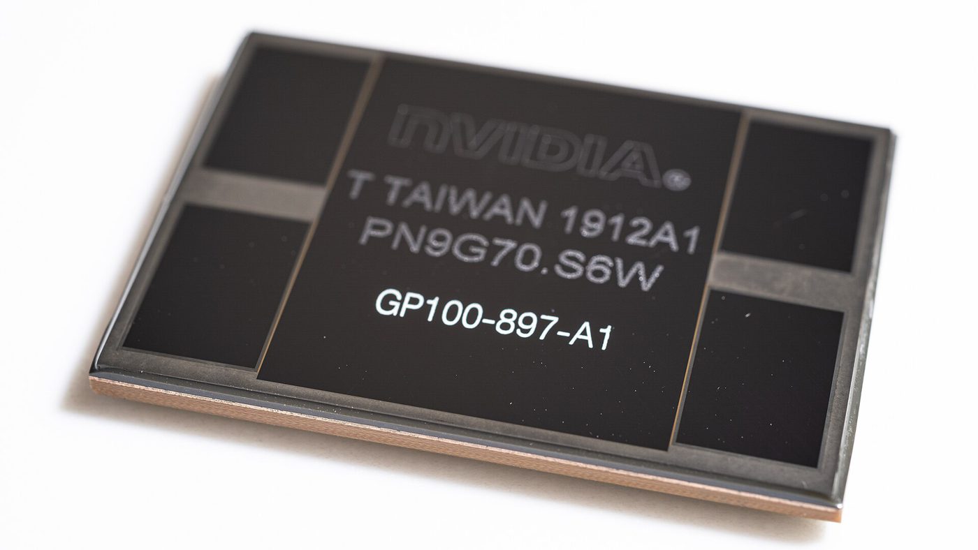 An NVIDIA Tesla P100 chip package: one large GPU die in the middle with four memory stacks around it on a shared base